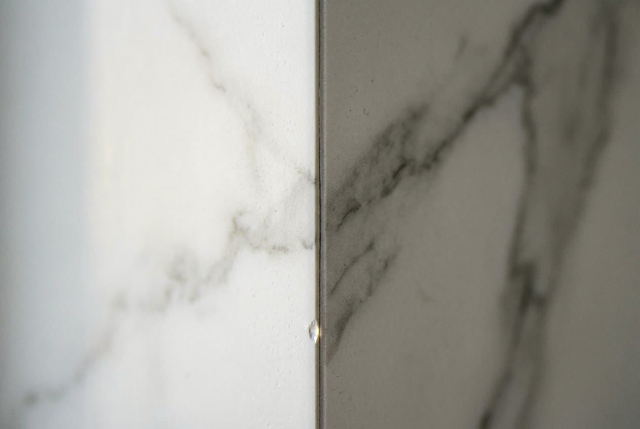 Close-up of a mitered marble-look tile corner